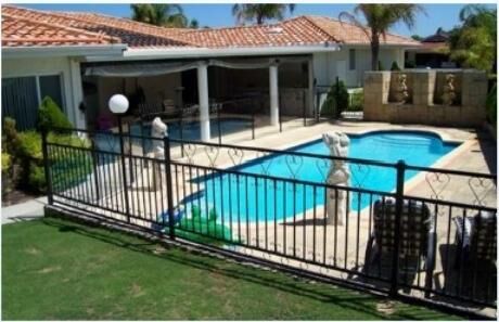 Black aluminium pool fence by a patio