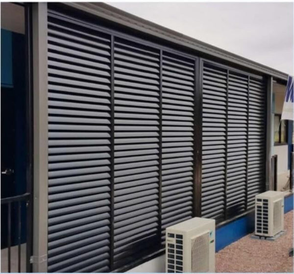 Angled privacy slats screening a house side