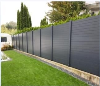 Black aluminium privacy slat fence along a lawn