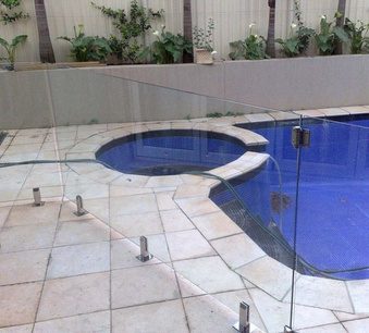 Frameless glass pool fence around a curved pool