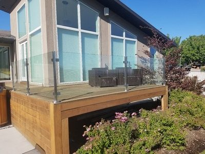 Post and clamp glass balustrade on a raised timber deck
