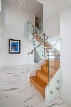 Glass panels on standoffs up a staircase