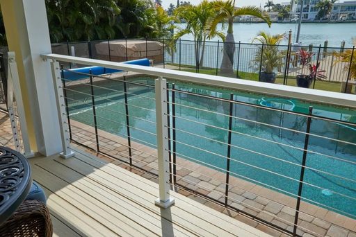 Deck by a pool with wire balustrade