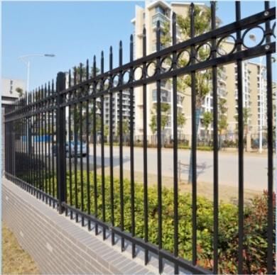 Black ring top security fence along a street