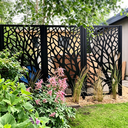 Laser-cut screen fence along a garden